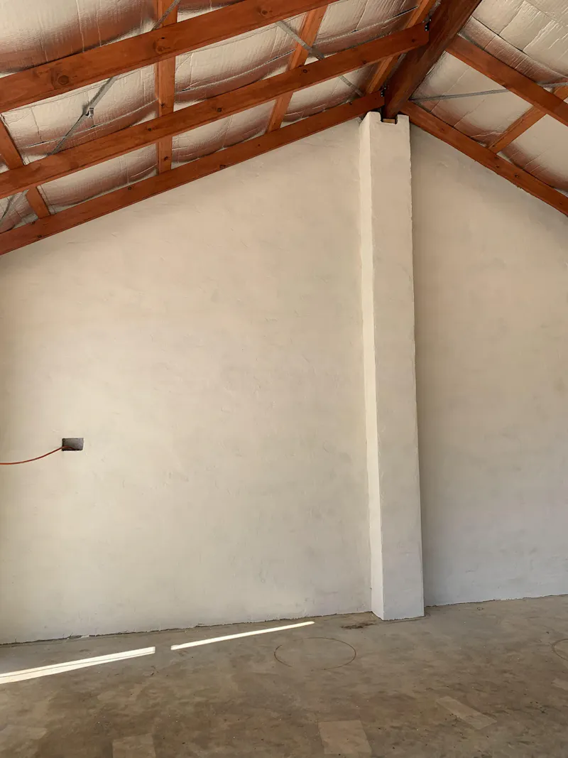 Customer photo — Chai on rendered shed wall (Jonathon W.)