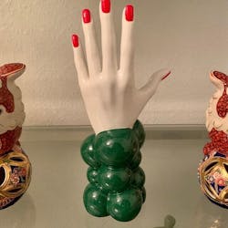 Hand "Thoughts" green with red nails