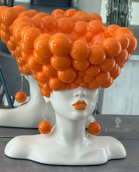 Sculpture of a woman "Thoughts" in an orange color
