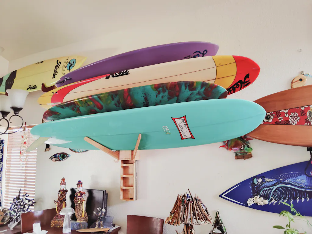 Well-organized surf room with wall-mounted board racks and coastal decor