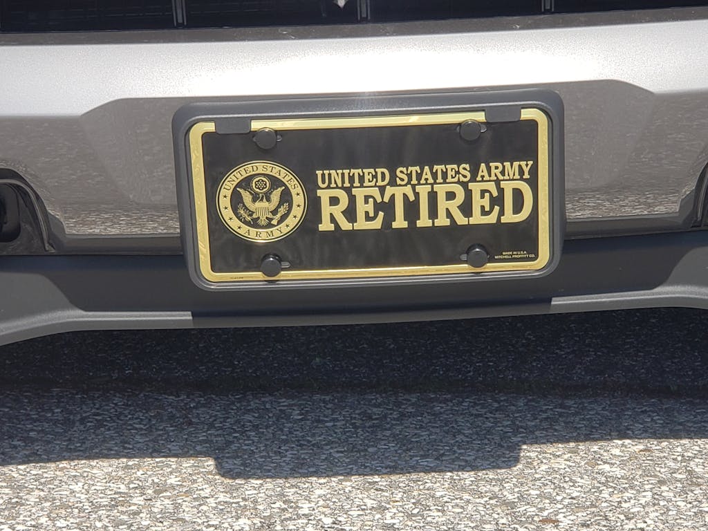 U.S. Army Retired Crest in Gold on Black Metal License Plate Military