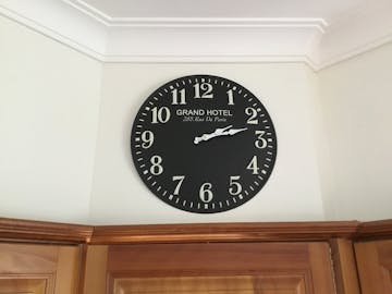 Grand Hotel Embossed Numbers Domed Metal Wall Clock, Black, 40cm