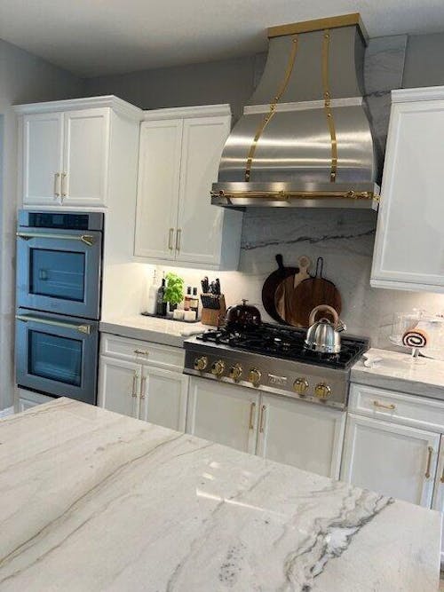 RHM Curved Stainless Steel Custom Range Hoods with Brass Accents SH1-2TRM