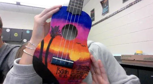 Students building ukulele kits in class