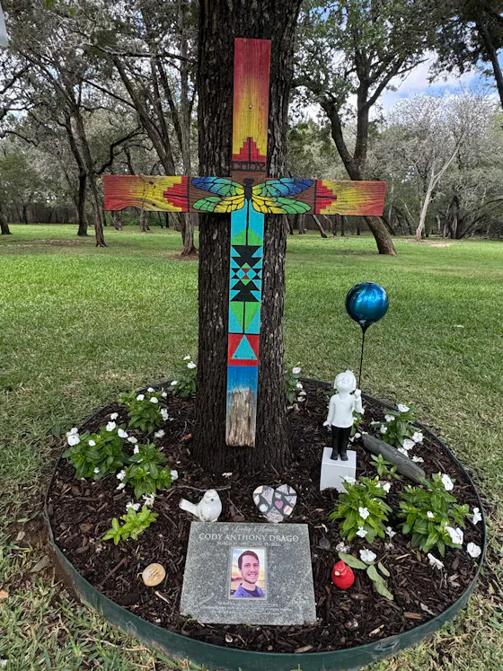 AeroCherub with blue balloon in a memorial garden