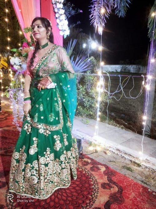 Abundant Green Mirror Work Net Reception Wear Lehenga Choli